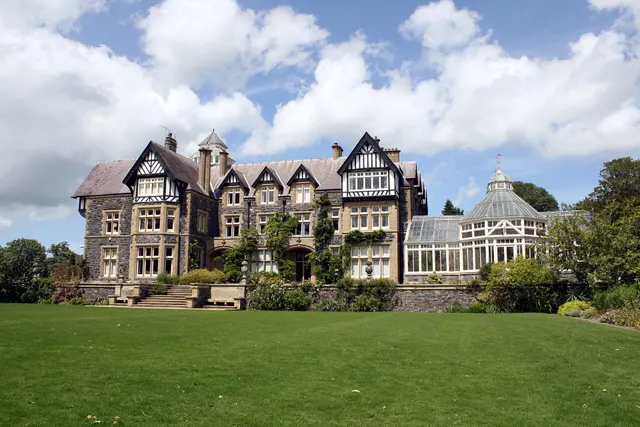 Deep green, healthy lawn stretching in front of a large home